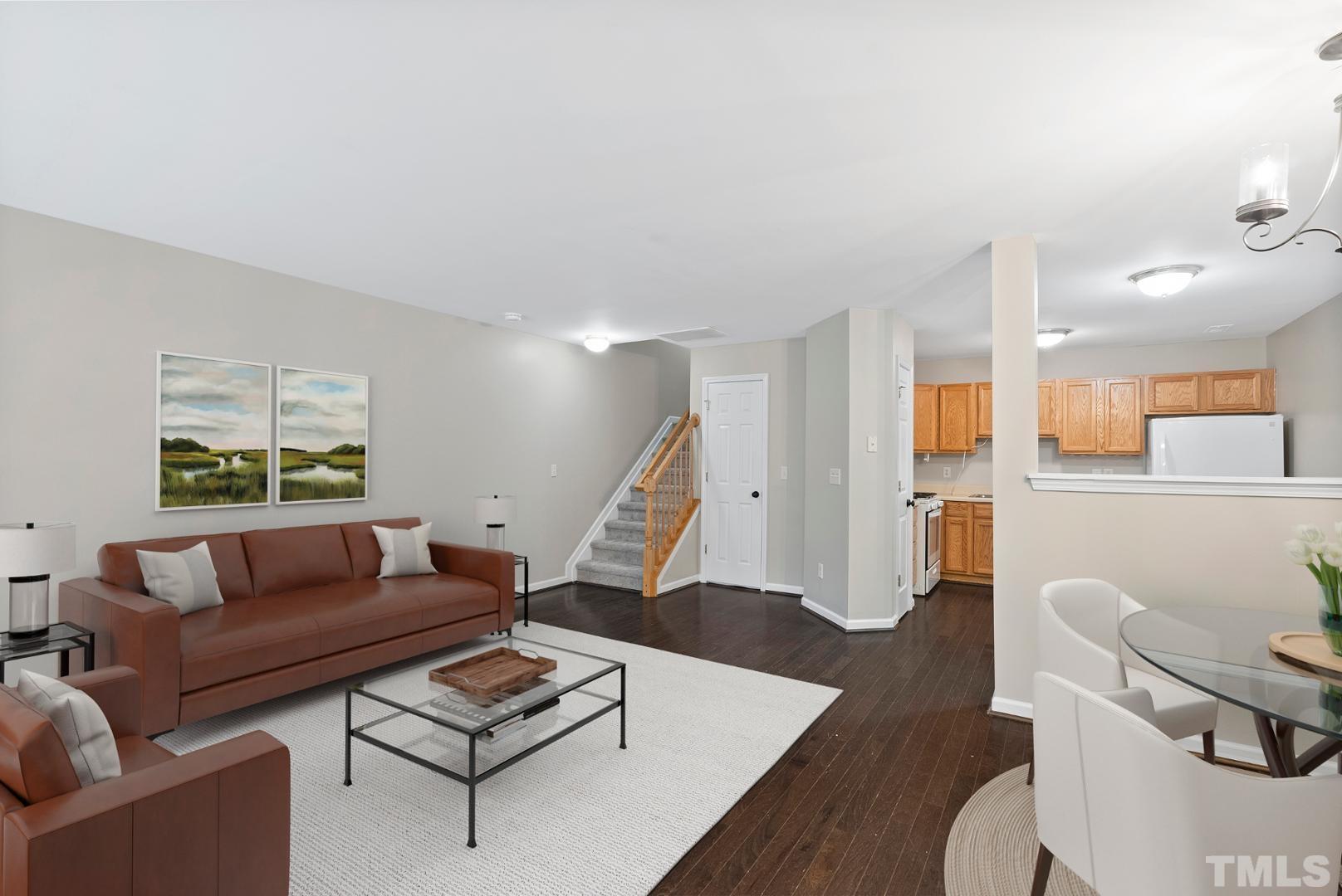 3011 Barrymore Street, Unit 107 Raleigh, NC 27603 - Photo 1 of 33 a living room with furniture and a wooden floor