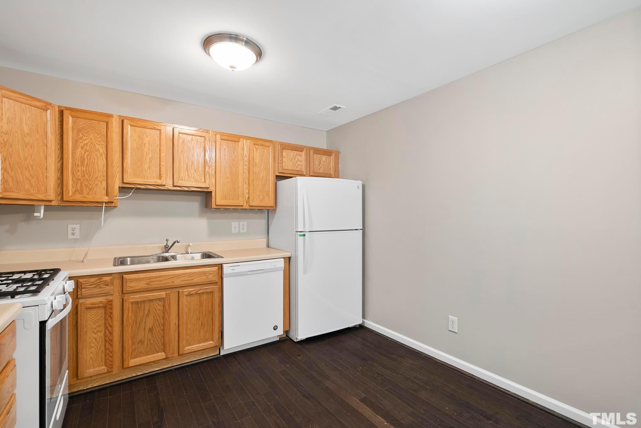 3011 Barrymore Street, Unit 107 Raleigh, NC 27603 - Photo 15 of 33 a view of a kitchen with wooden floor