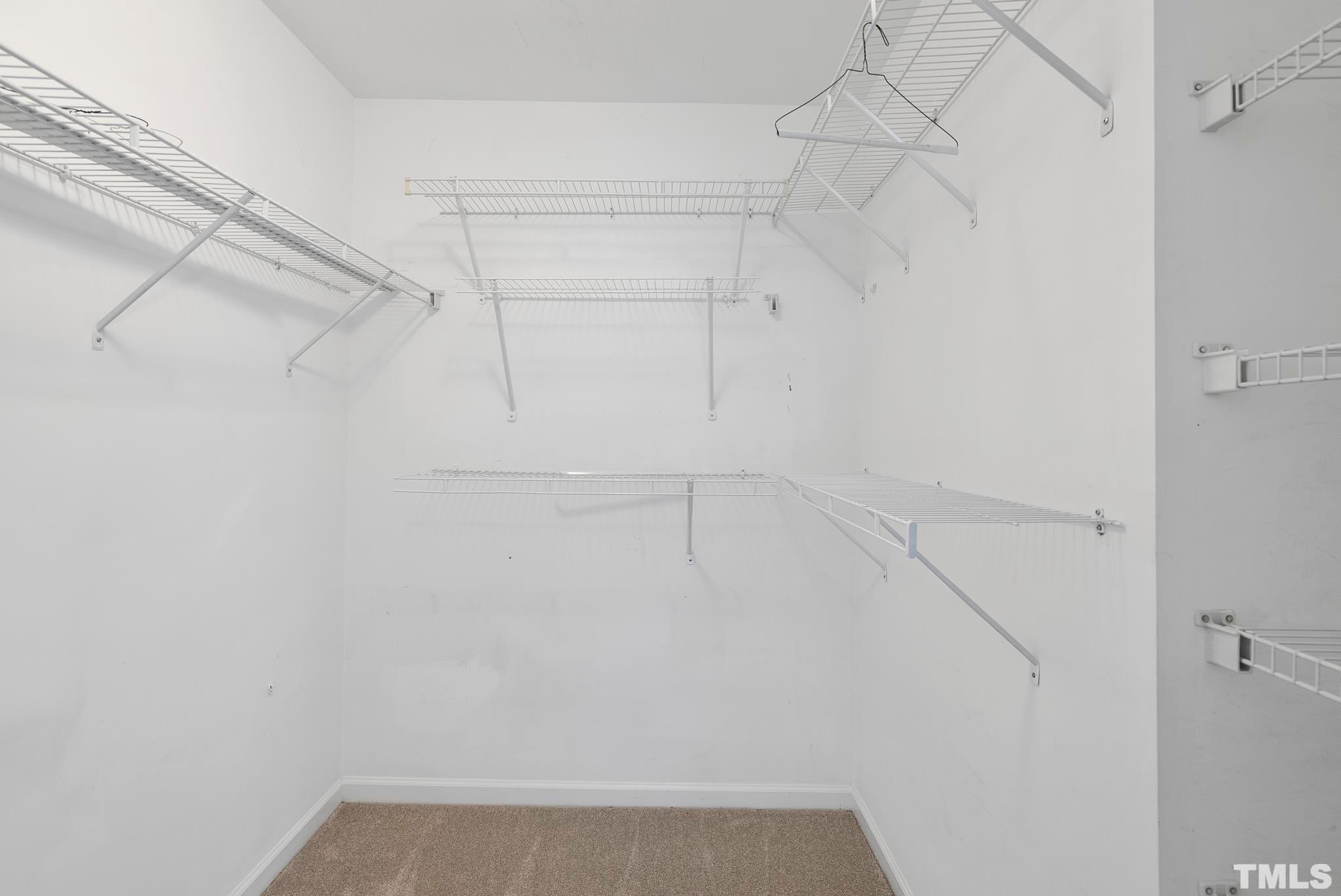 3011 Barrymore Street, Unit 107 Raleigh, NC 27603 - Photo 20 of 33 a view of a room with racks on the wall
