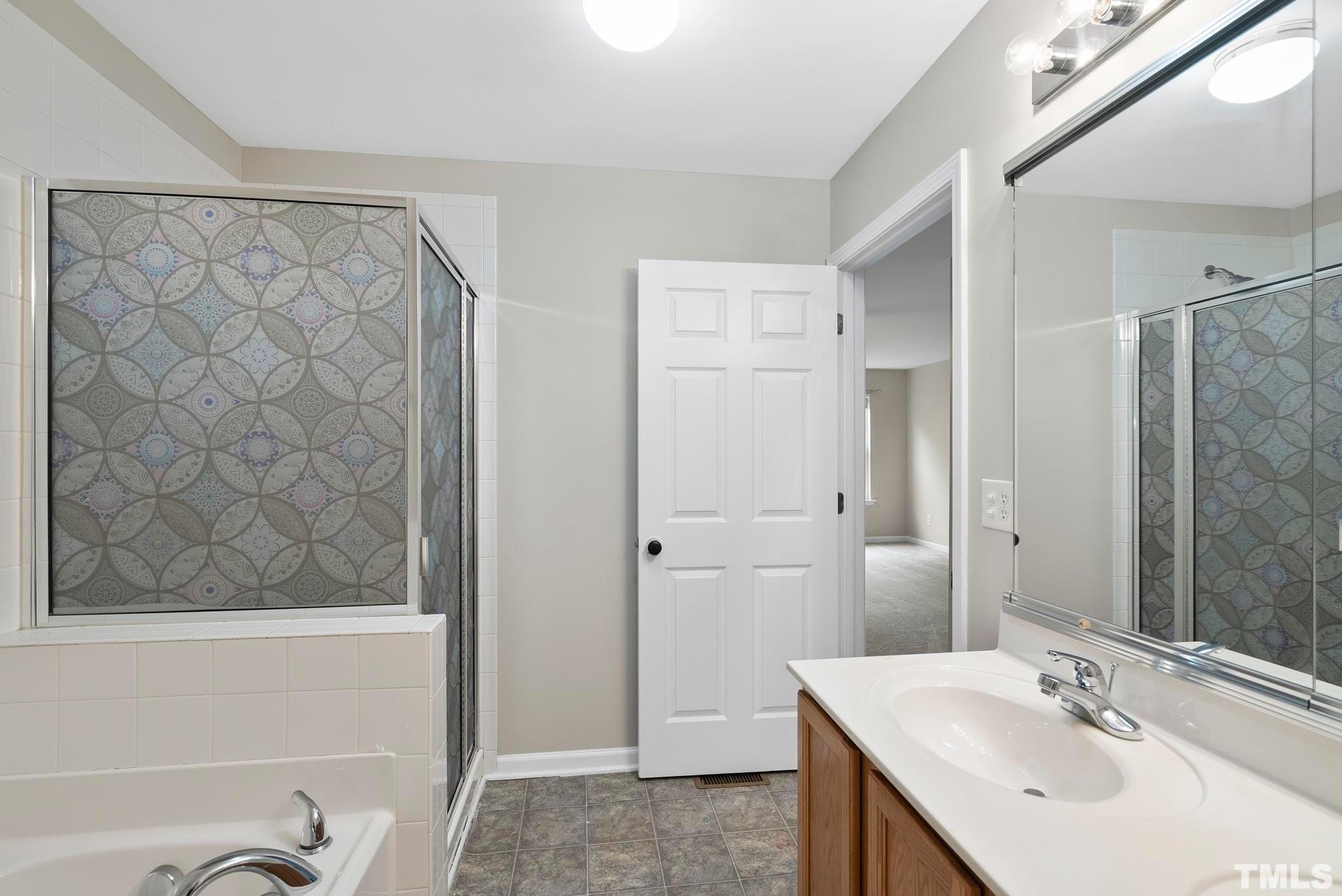3011 Barrymore Street, Unit 107 Raleigh, NC 27603 - Photo 21 of 33 a bathroom with a sink and a mirror