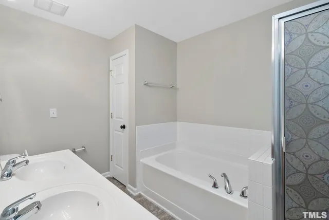 a white bath tub sitting next to a white sink