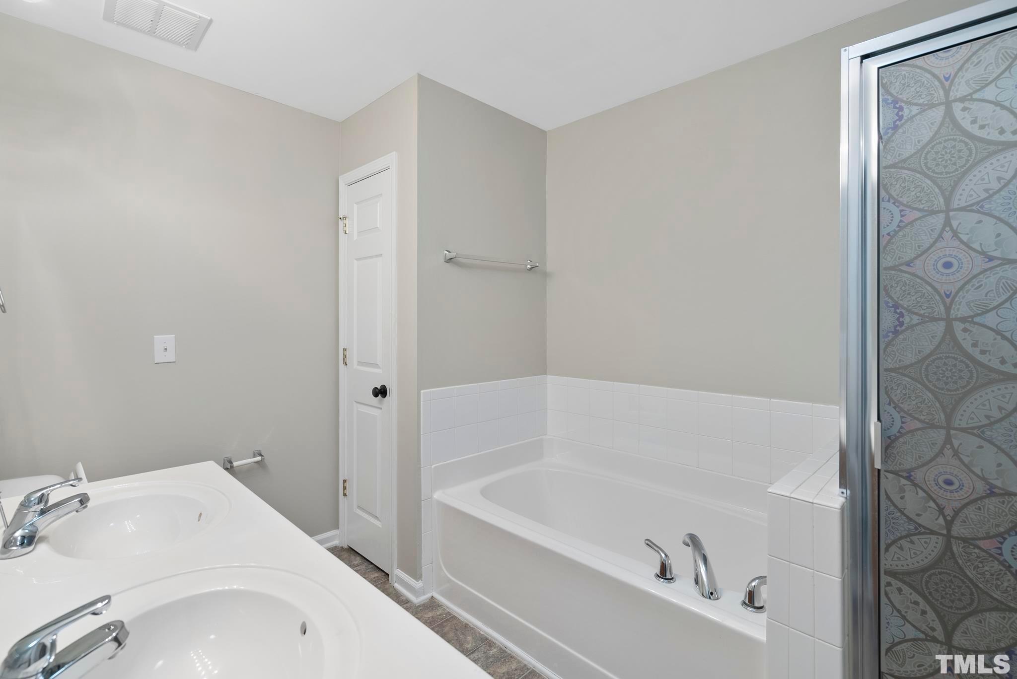 3011 Barrymore Street, Unit 107 Raleigh, NC 27603 - Photo 24 of 33 a white bath tub sitting next to a white sink