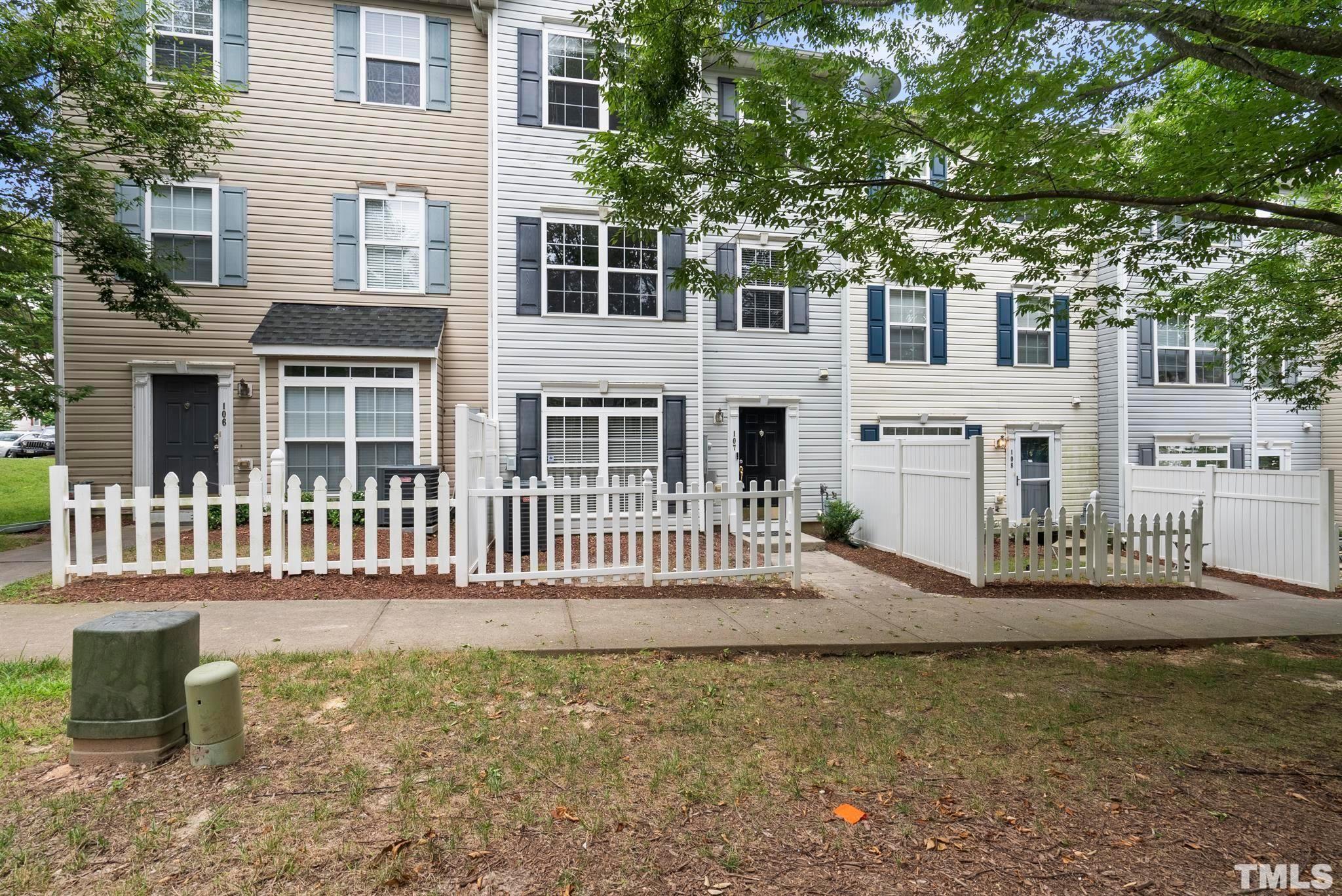 3011 Barrymore Street, Unit 107 Raleigh, NC 27603 - Photo 3 of 33 a front view of a house with a garden