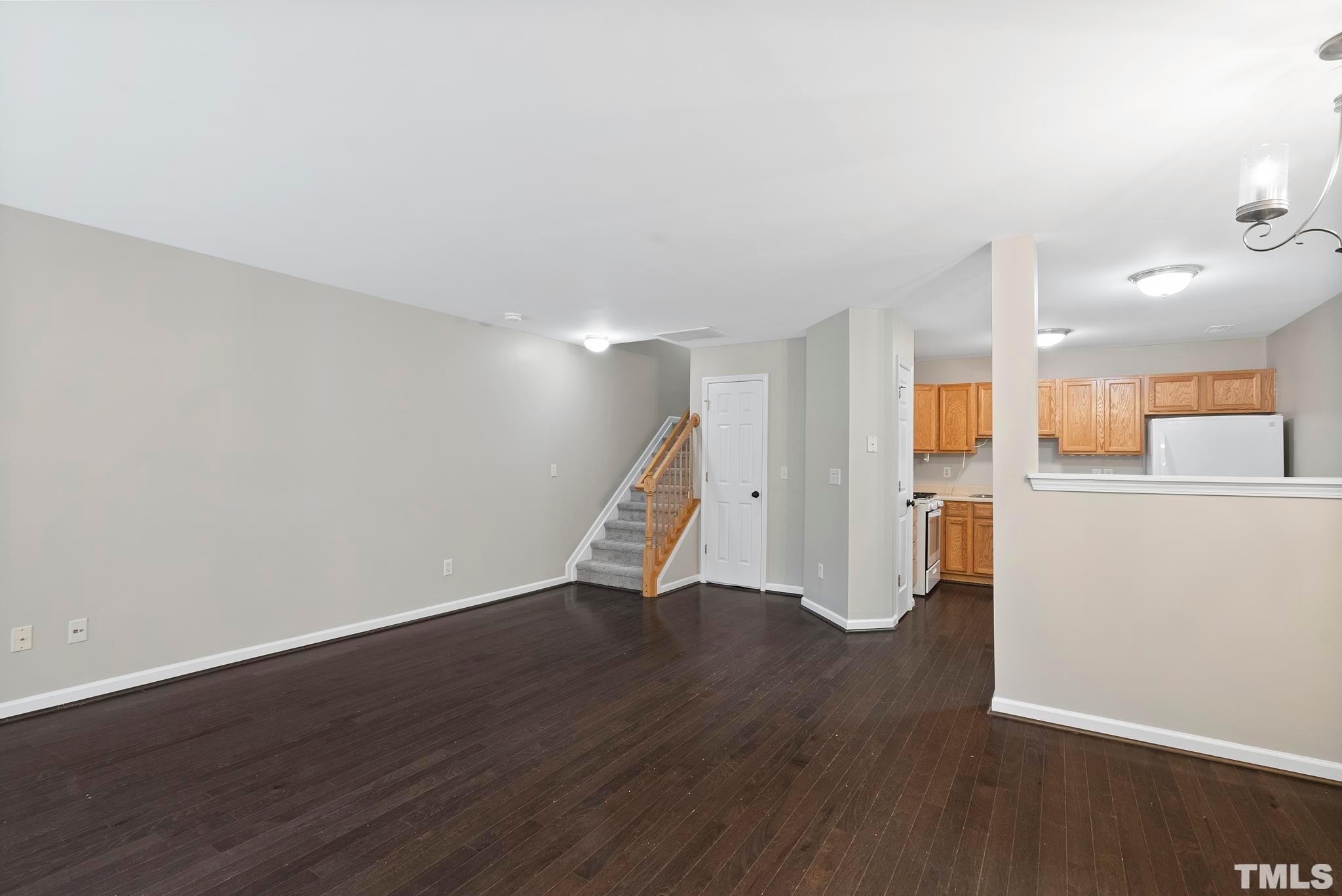 3011 Barrymore Street, Unit 107 Raleigh, NC 27603 - Photo 5 of 33 a view of a kitchen with wooden floor and a sink
