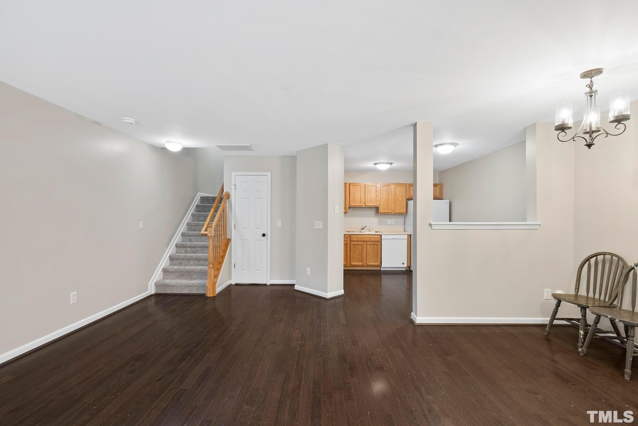 3011 Barrymore Street, Unit 107 Raleigh, NC 27603 - Photo 6 of 33 a view of a room with wooden floor and staircase