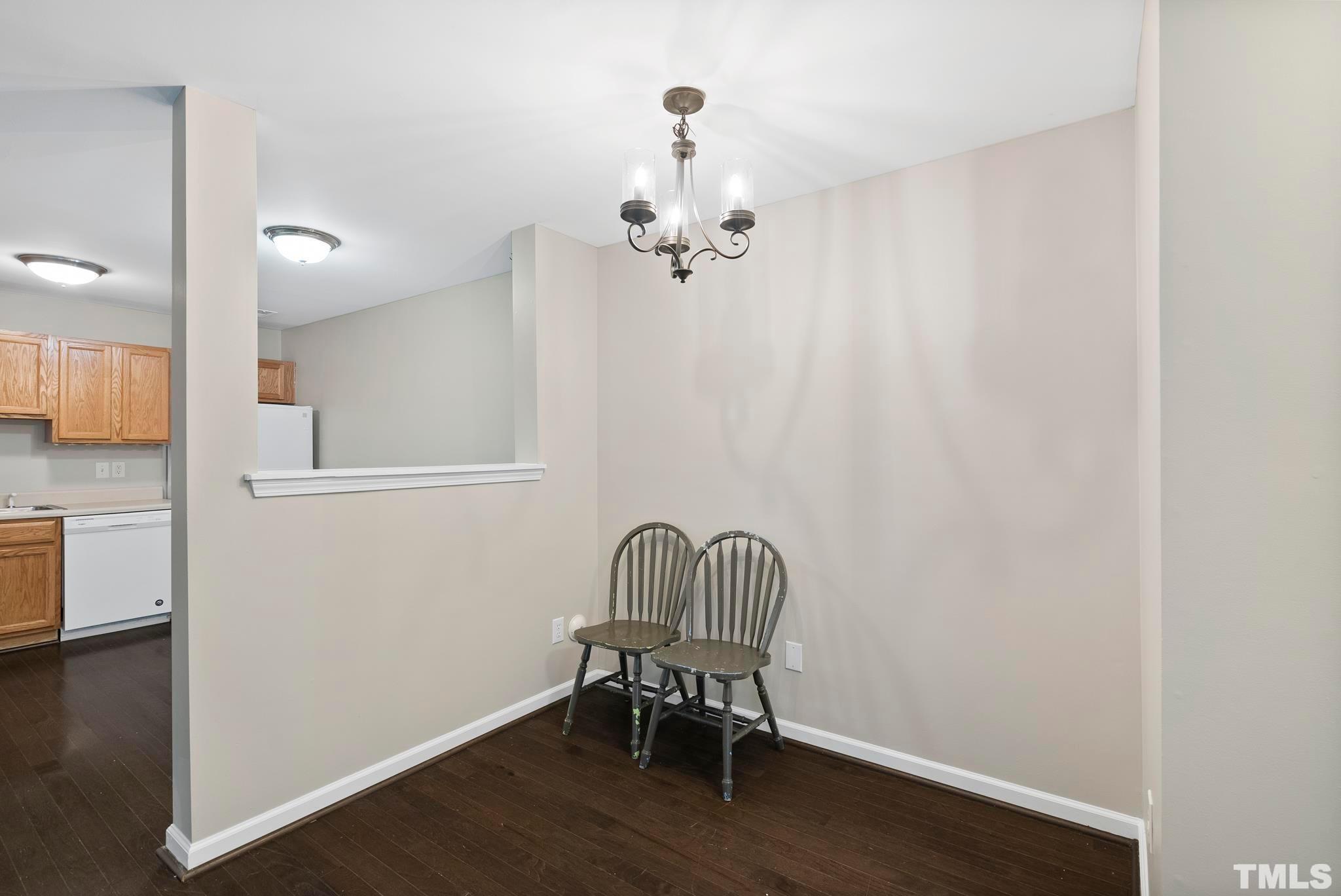 3011 Barrymore Street, Unit 107 Raleigh, NC 27603 - Photo 10 of 33 a view of a room with wooden floor table and chairs