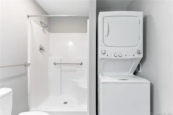 a bathroom with a shower a mirror and a shower