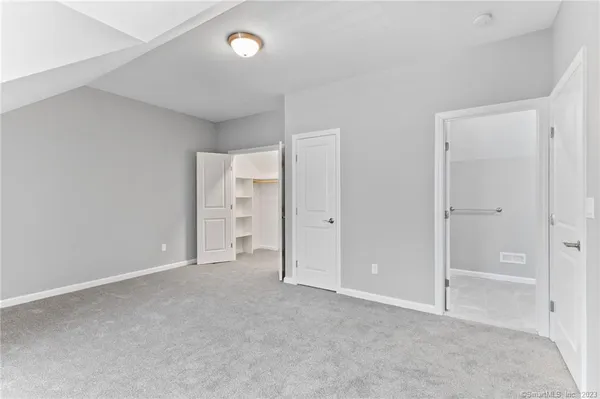 a view of an empty room and closet area