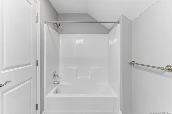 a bathroom with a shower and a bath tub