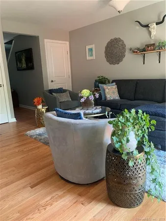 a view of a living room with furniture and flowers