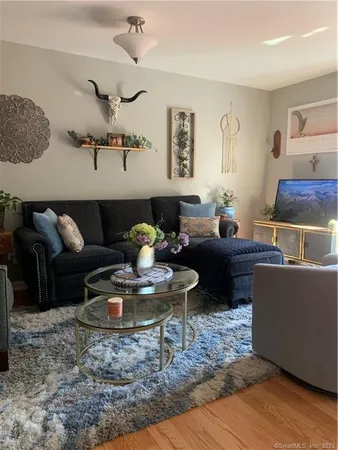 a living room with furniture and wooden floor