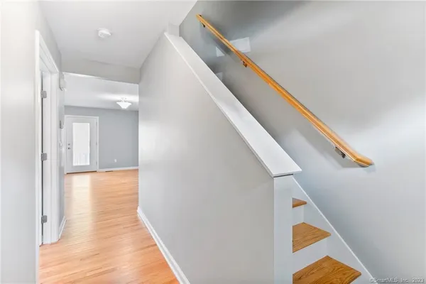 a view of hallway with wooden floor