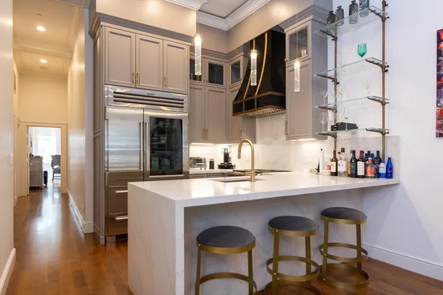 a kitchen with stainless steel appliances granite countertop a stove top oven a sink and cabinets