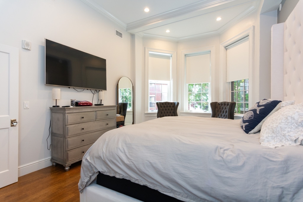 288 Commonwealth Avenue, Unit 1 Boston, MA 02115 - Photo 12 of 36 a bedroom with a bed and a flat screen tv