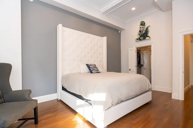 a bed sitting in a bedroom next to a window