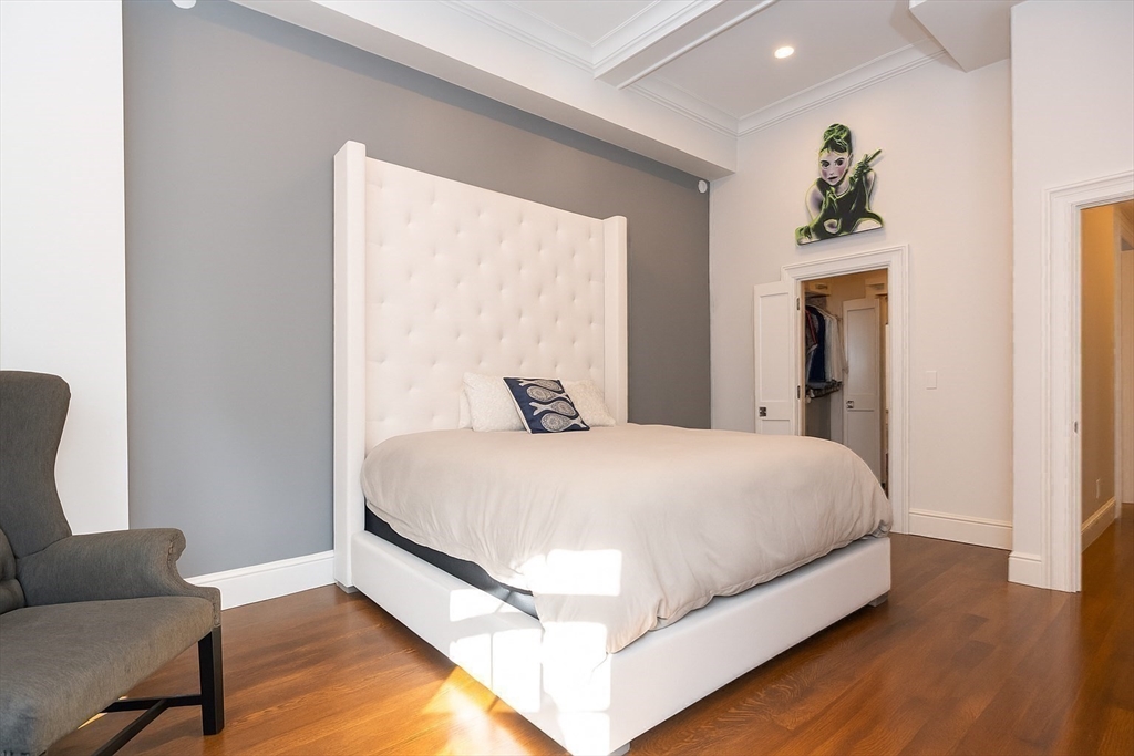 288 Commonwealth Avenue, Unit 1 Boston, MA 02115 - Photo 14 of 36 a bed sitting in a bedroom next to a window