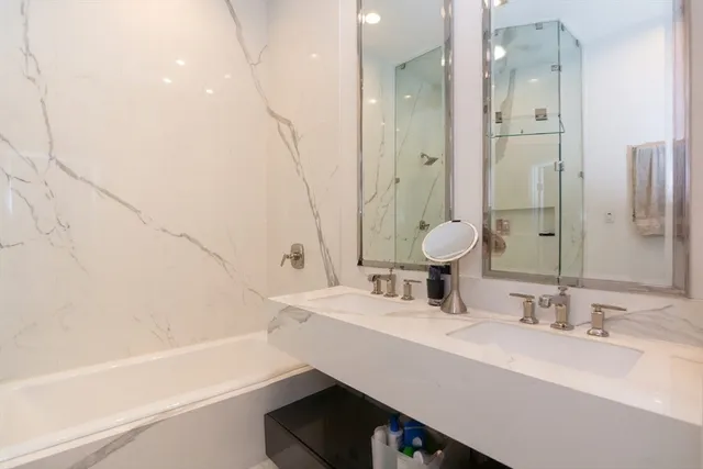 a bathroom with a bathtub and a sink