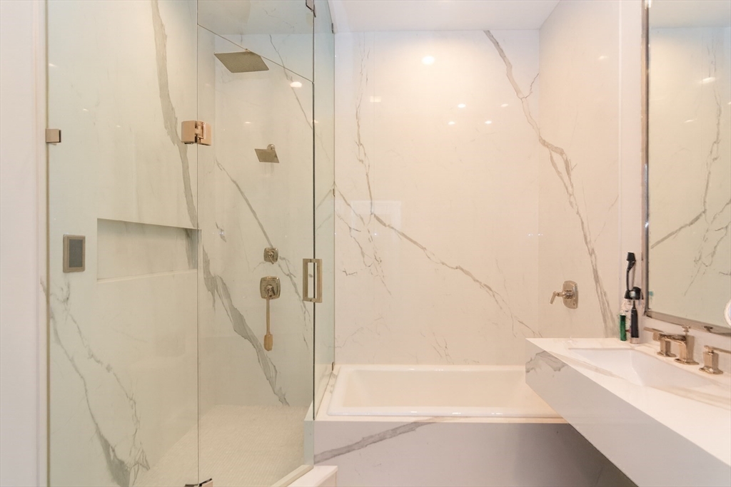 288 Commonwealth Avenue, Unit 1 Boston, MA 02115 - Photo 19 of 36 a bathroom with a bathtub and a shower