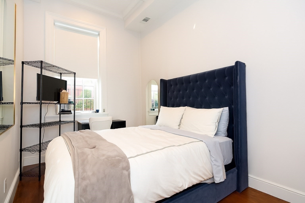 288 Commonwealth Avenue, Unit 1 Boston, MA 02115 - Photo 22 of 36 a bedroom with a bed and a flat screen tv