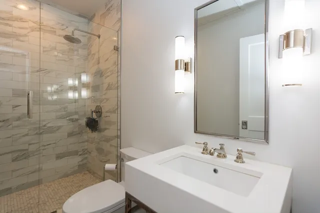 a bathroom with a sink toilet and shower