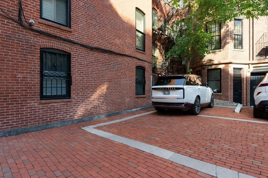 288 Commonwealth Avenue, Unit 1 Boston, MA 02115 - Photo 30 of 36 a view of a car park in front of house