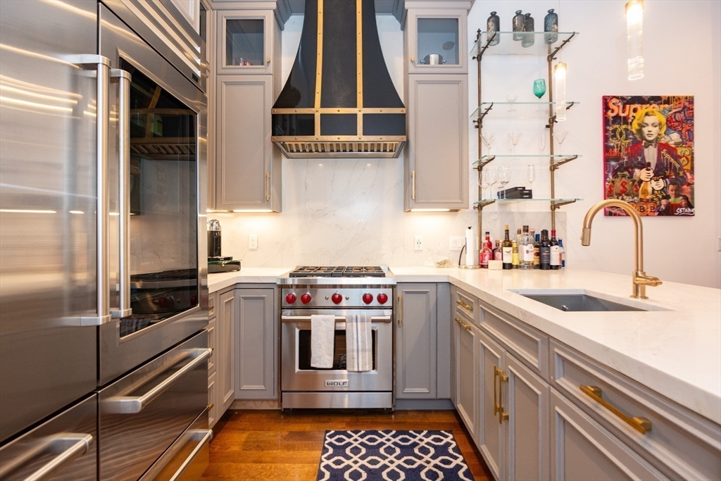 288 Commonwealth Avenue, Unit 1 Boston, MA 02115 - Photo 3 of 36 a kitchen with stainless steel appliances granite countertop a sink and a stove