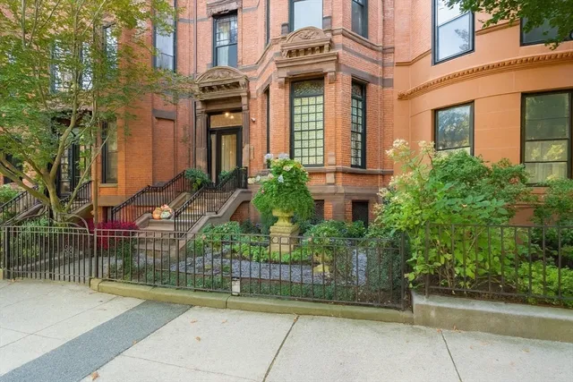 front view of a brick house with a small yard