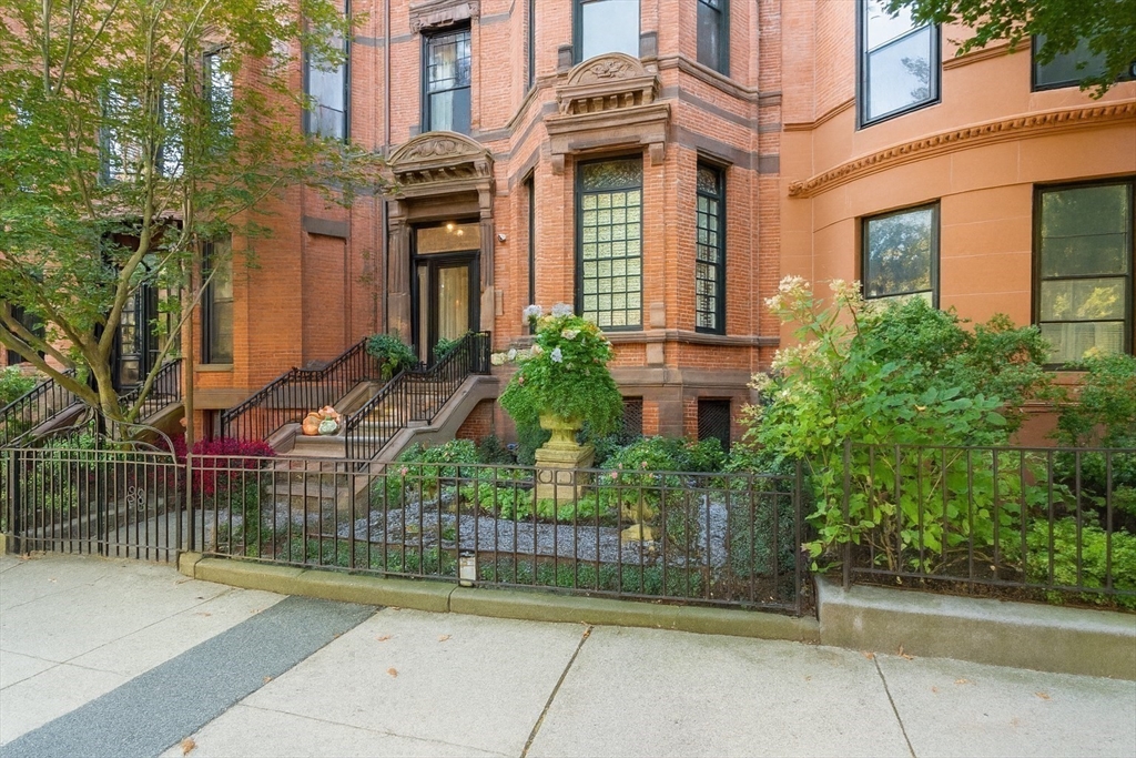 288 Commonwealth Avenue, Unit 1 Boston, MA 02115 - Photo 32 of 36 front view of a brick house with a small yard