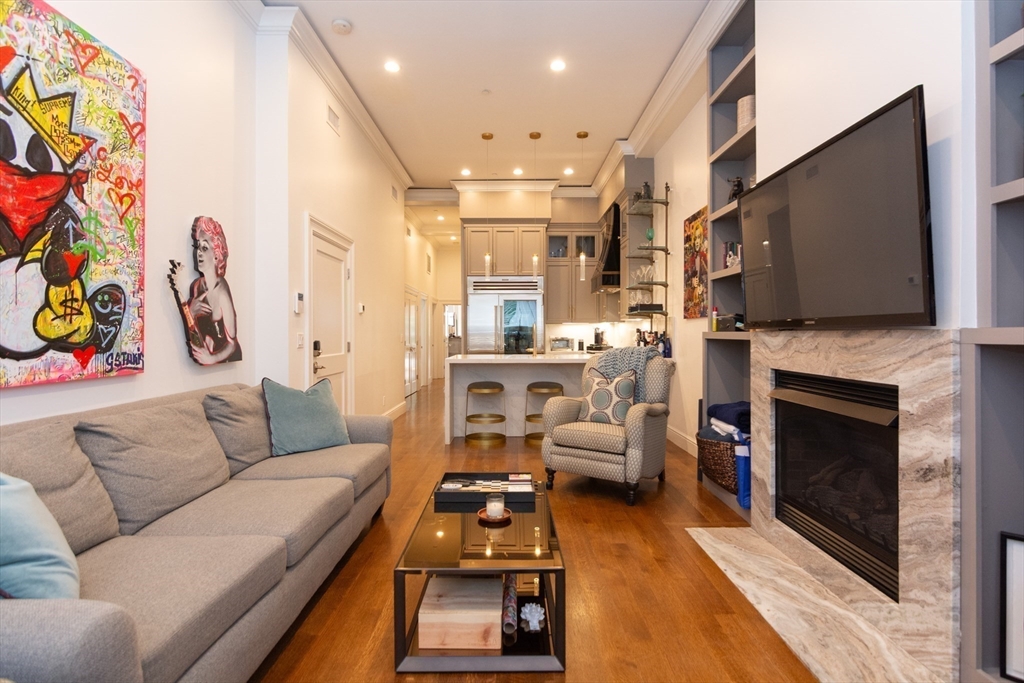 288 Commonwealth Avenue, Unit 1 Boston, MA 02115 - Photo 5 of 36 a living room with furniture a flat screen tv and a fireplace