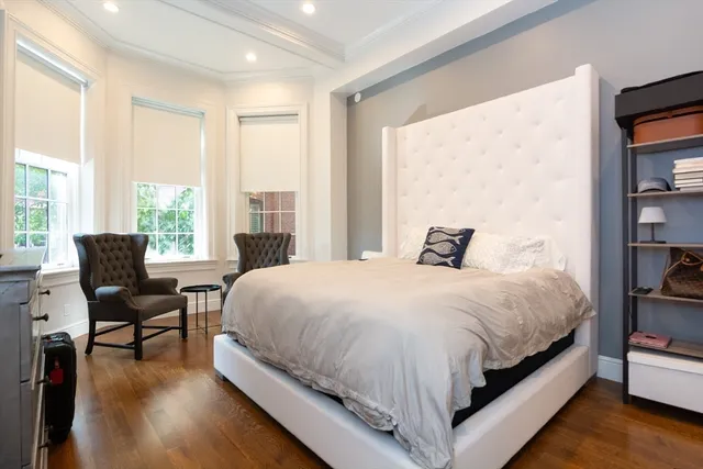 a large bed sitting in a bedroom next to a window