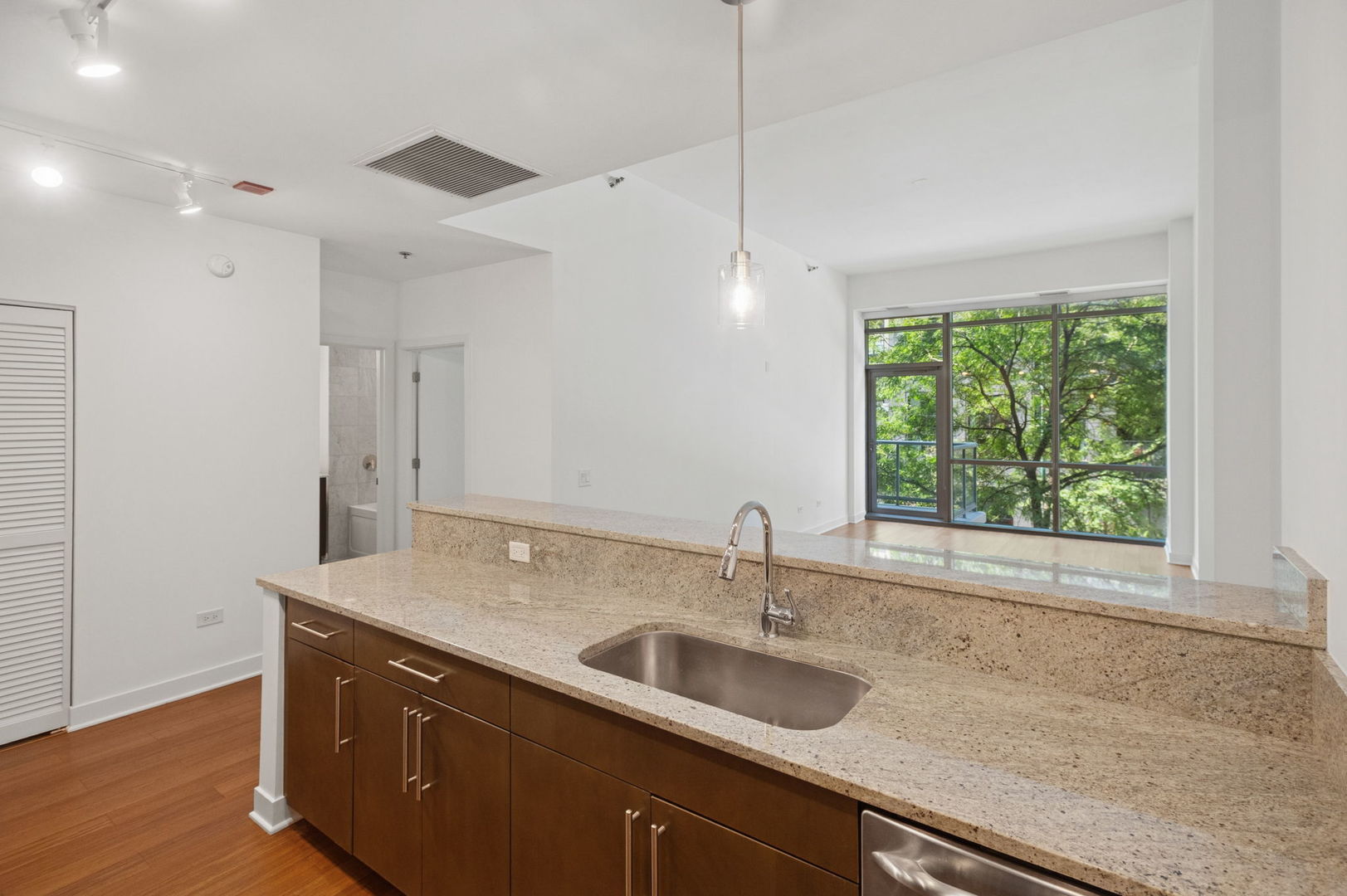 125 South Green Street, Unit 209A Chicago, IL 60607 - Photo 7 of 16 a kitchen with a sink cabinets and window