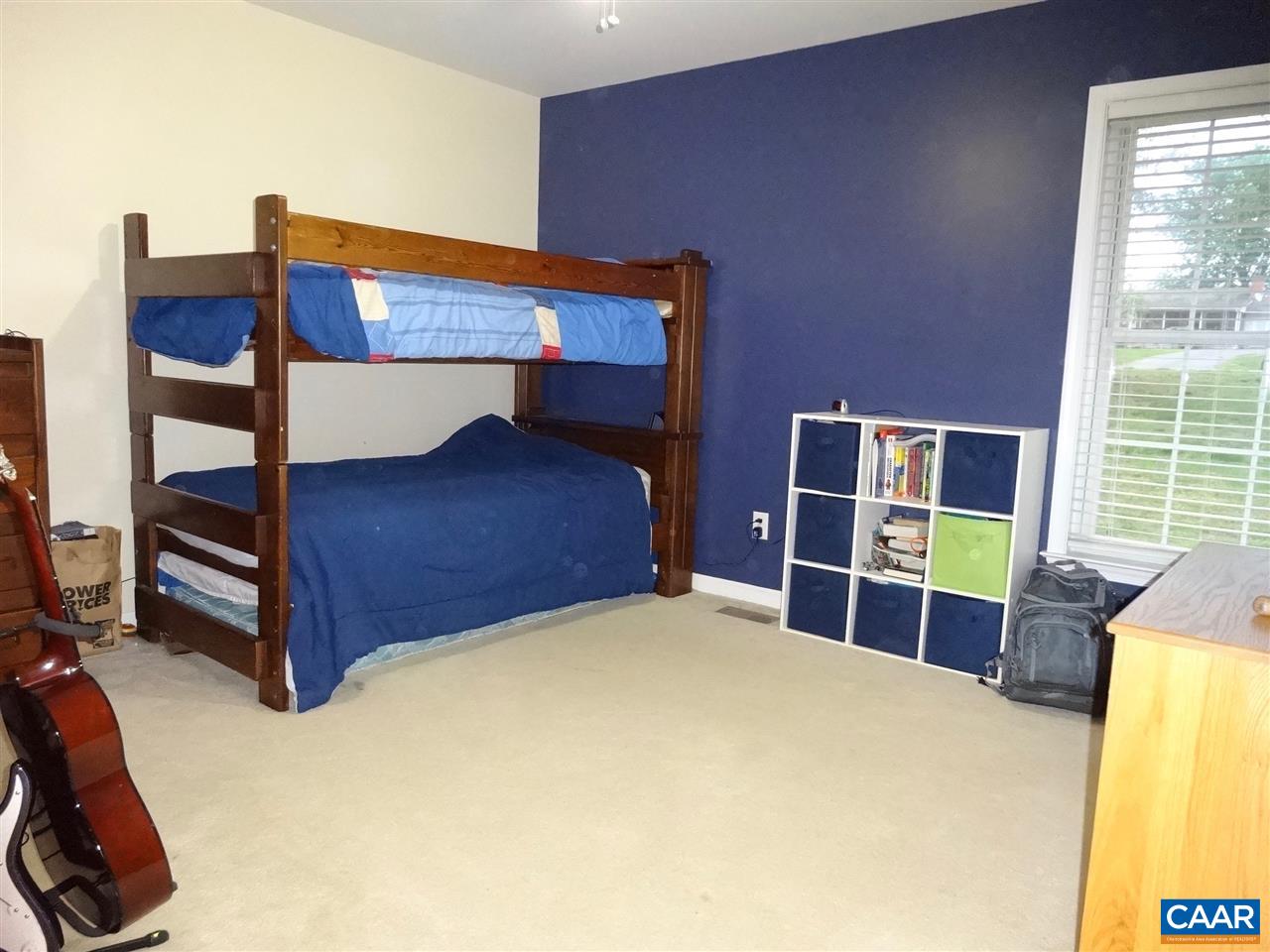 654 Miller School Road Charlottesville, VA 22903 - Photo 11 of 22 a bedroom with a bed and a dresser next to a window