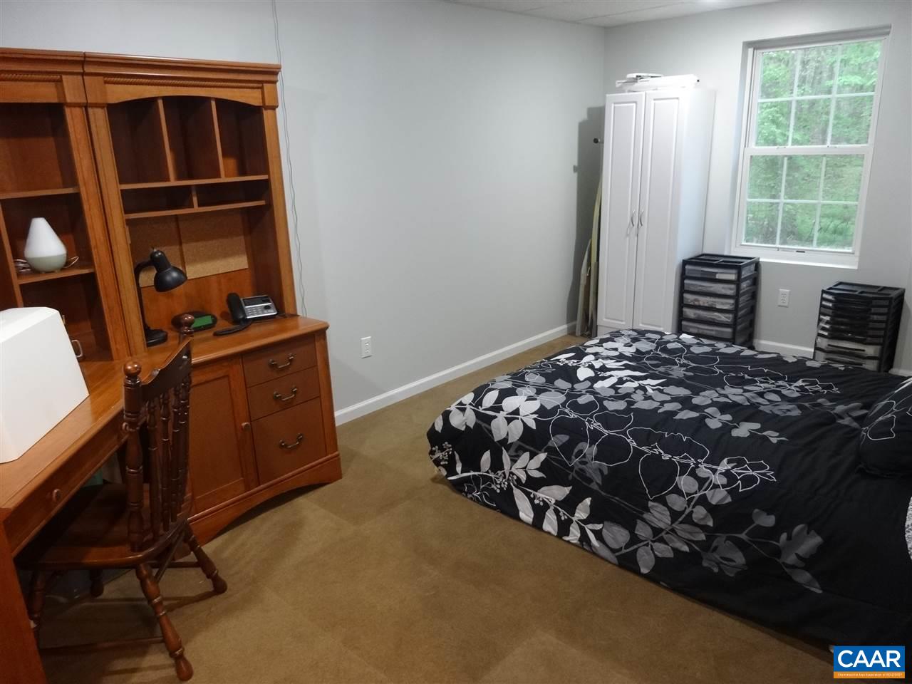 654 Miller School Road Charlottesville, VA 22903 - Photo 17 of 22 a bed sitting in a bedroom next to a window