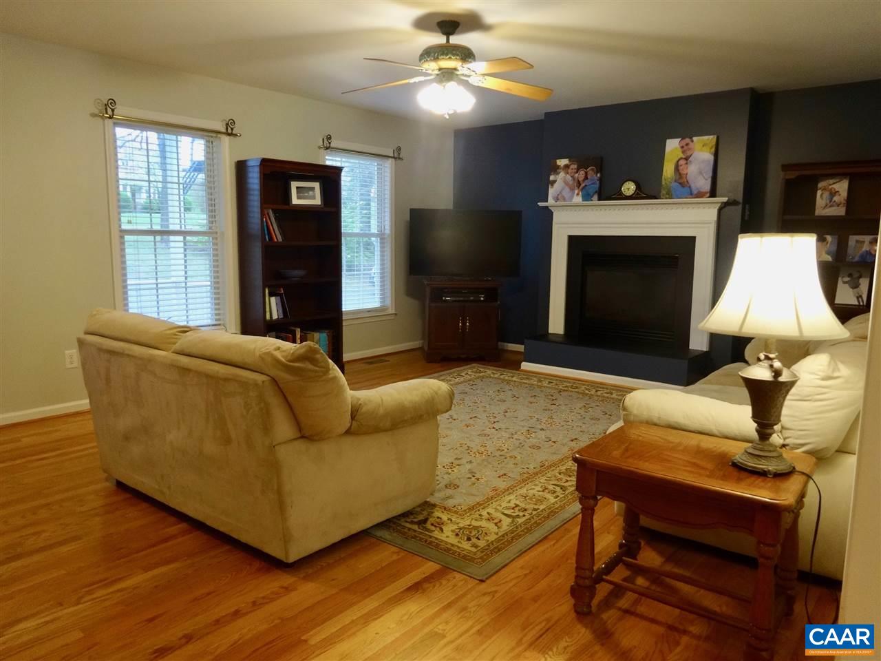 654 Miller School Road Charlottesville, VA 22903 - Photo 4 of 22 a living room with furniture a flat screen tv and a fireplace