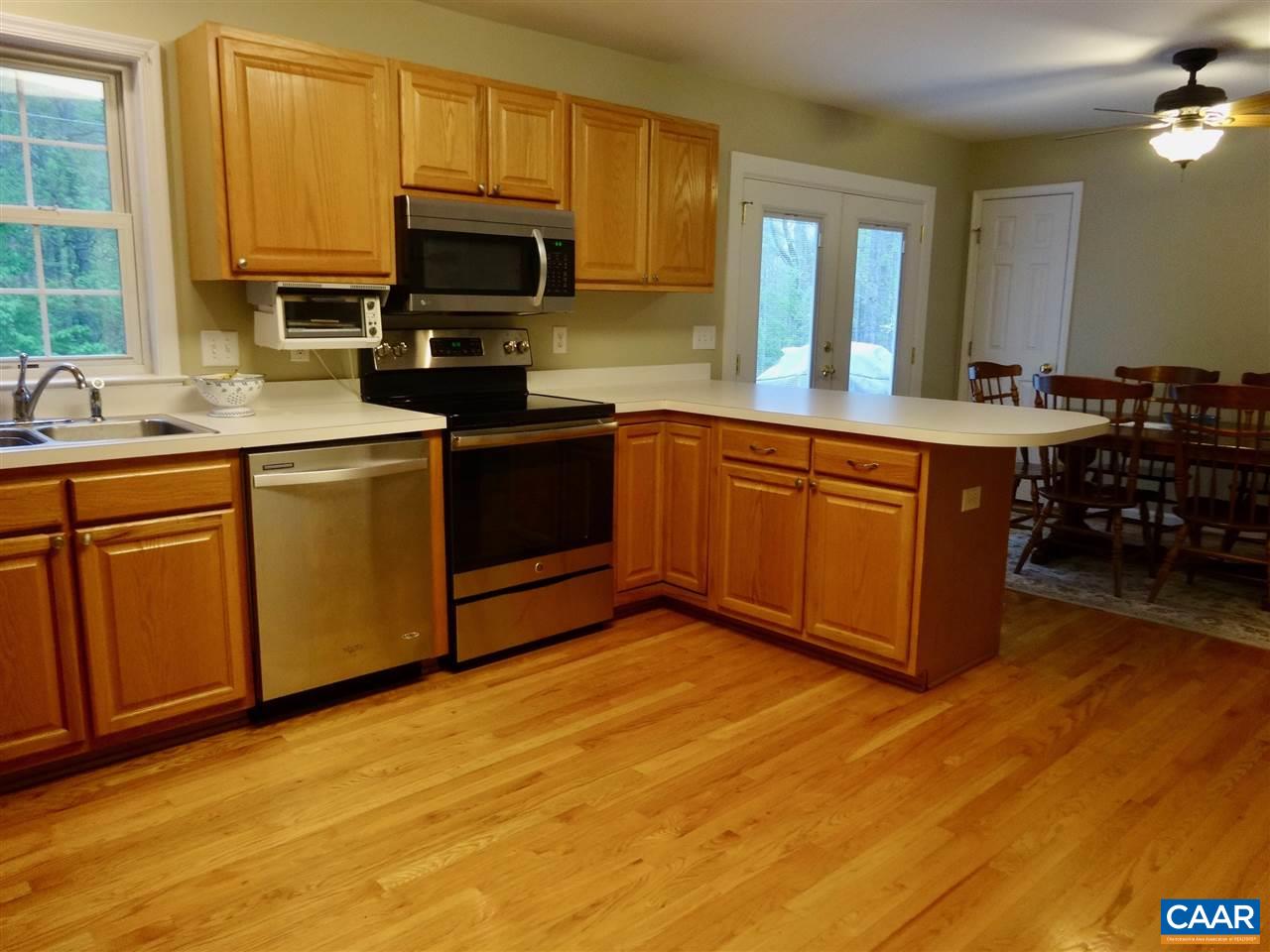 654 Miller School Road Charlottesville, VA 22903 - Photo 6 of 22 a kitchen with stainless steel appliances granite countertop a stove a sink and a microwave