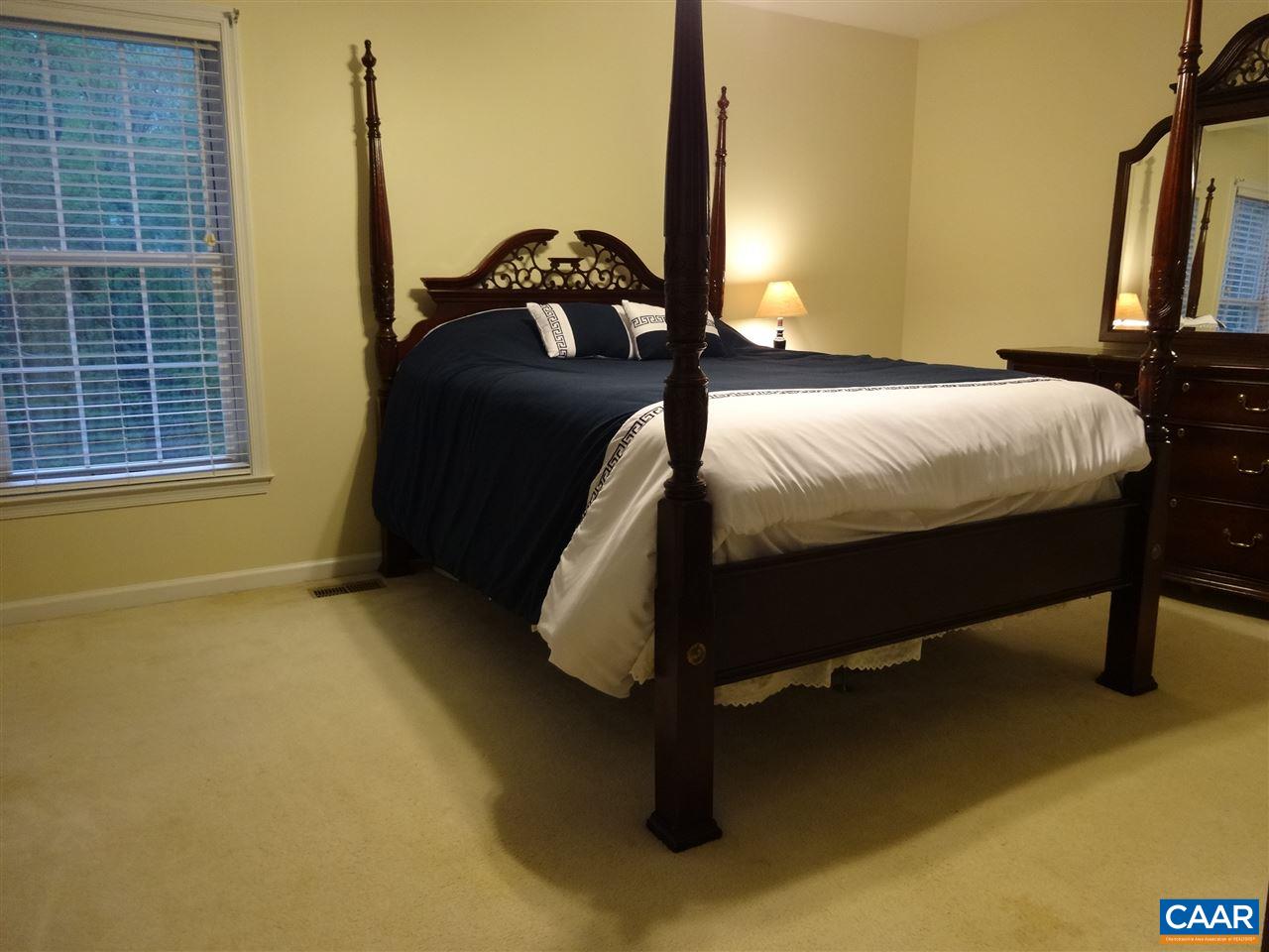 654 Miller School Road Charlottesville, VA 22903 - Photo 8 of 22 a bed sitting in a bedroom next to a window