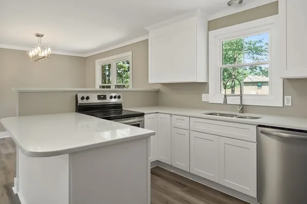 a kitchen with a sink a window and cabinets