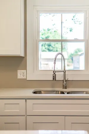 a kitchen with a sink stove and cabinets