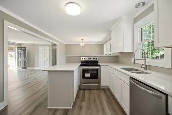 a kitchen with a cabinets appliances and a window
