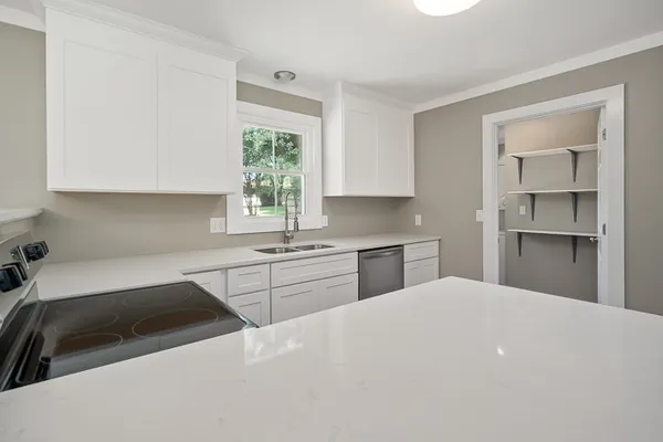 a view of storage and utility room with closet