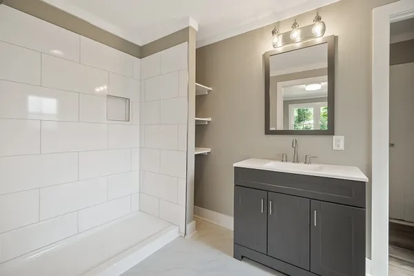 a bathroom with a tub sink and shower