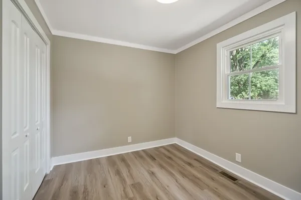 a view of room with window and hardwood floor
