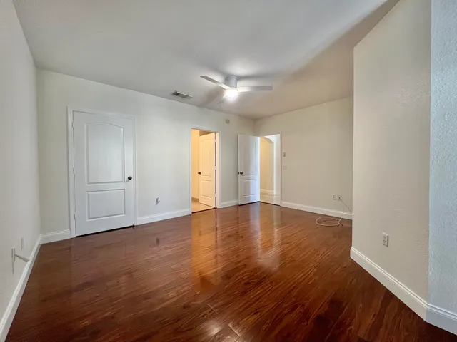 a view of a room with wooden floor