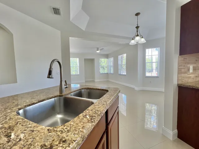 a kitchen with a faucet a sink and chandelier