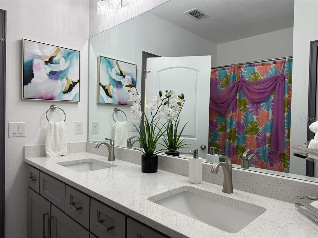 2050 Florida Development Road, Unit A Davenport, FL 33837 - Photo 12 of 17 a bathroom with a sink a vanity and a mirror