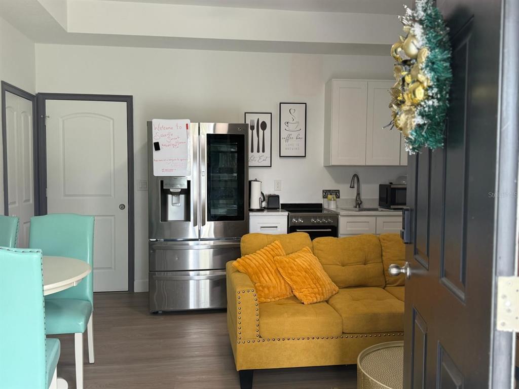 2050 Florida Development Road, Unit A Davenport, FL 33837 - Photo 2 of 17 a living room with furniture and a chandelier