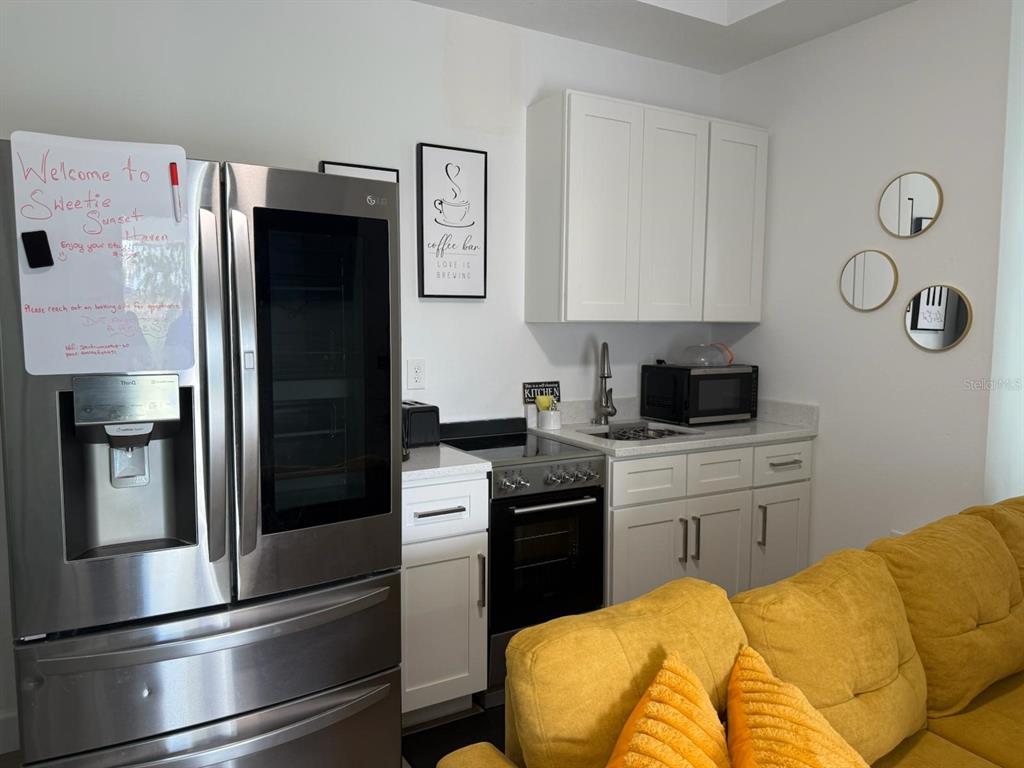 2050 Florida Development Road, Unit A Davenport, FL 33837 - Photo 3 of 17 a kitchen with a refrigerator and cabinets