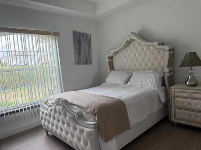 a bedroom with a bed and a window