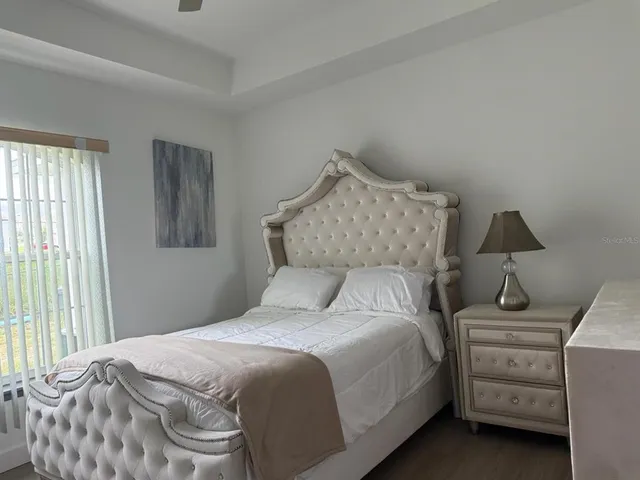 a bedroom with a bed and a lamp