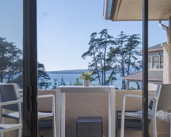 a view of a balcony dining table and chairs